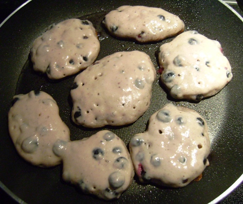 blueberry pancakes frying pan ready to flip