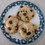 Freshly baked chocolate chip cookies on a decorative blue and white plate, showcasing their soft, chewy texture and generous chocolate chips for a classic homemade treat.