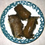 Top-view of three stuffed grape leaves.