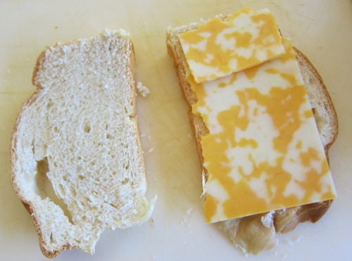 putting cheese on top of challah slice