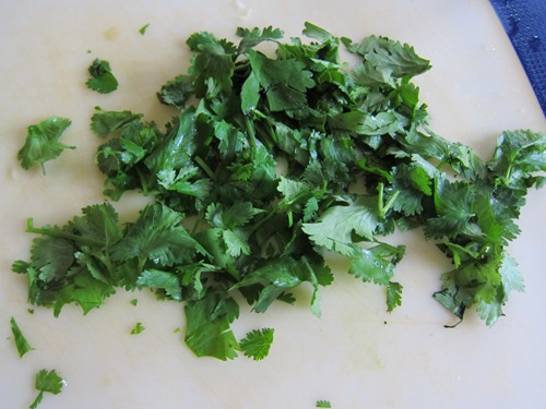 Chopped cilantro on wooden board close-up Stock Photo by ©belchonock  44324281