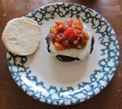 making black bean cheeseburger with salsa, cheese and veggie patty