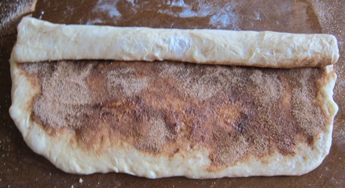 rolling the dough for cinnamon rolls