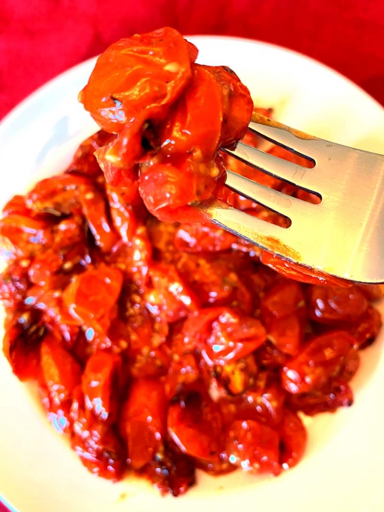 eating roasted cherry tomatoes with a fork