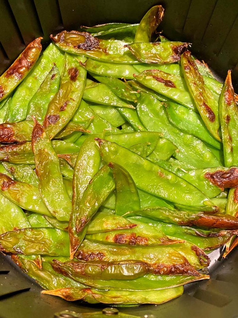 air fryer roasted snow peas in an air fryer basket