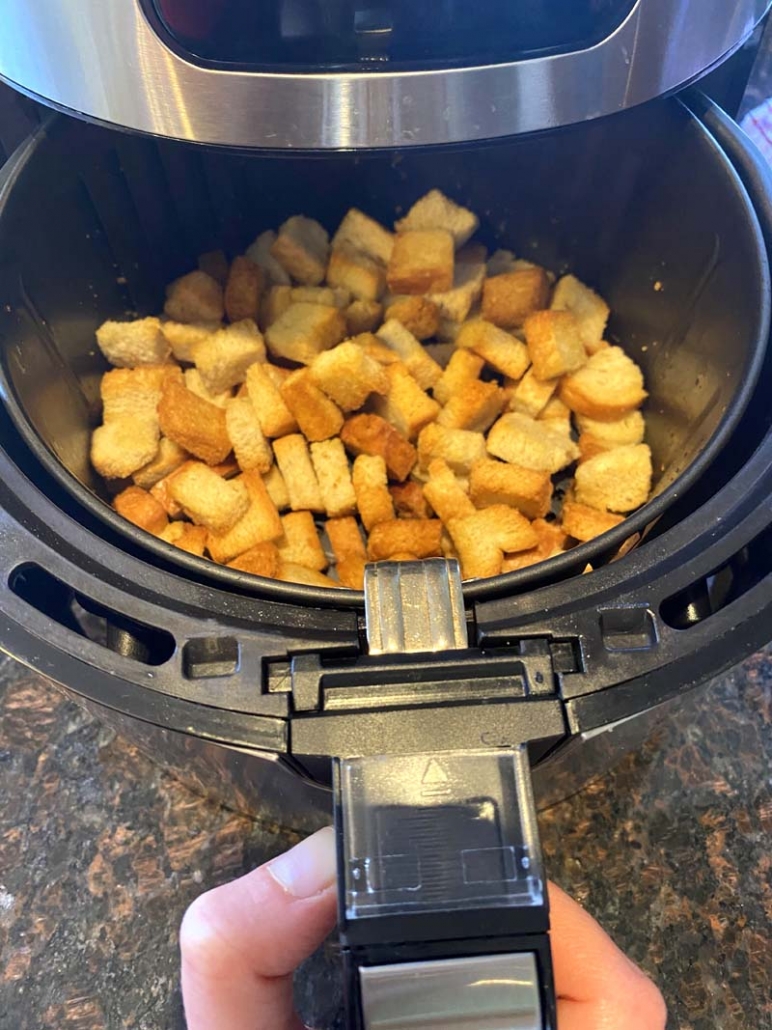 baked croutons in an air fryer basket 