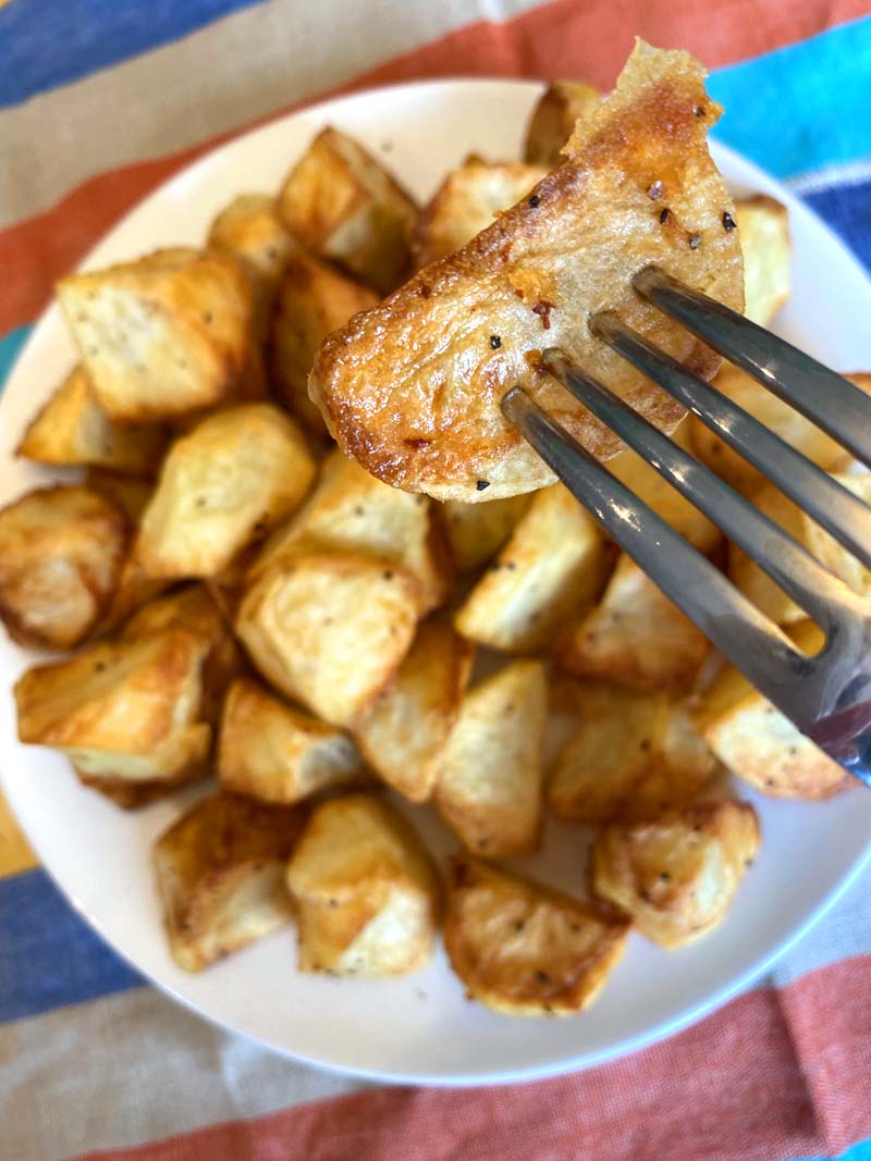 An air fryer roasted potato on a fork