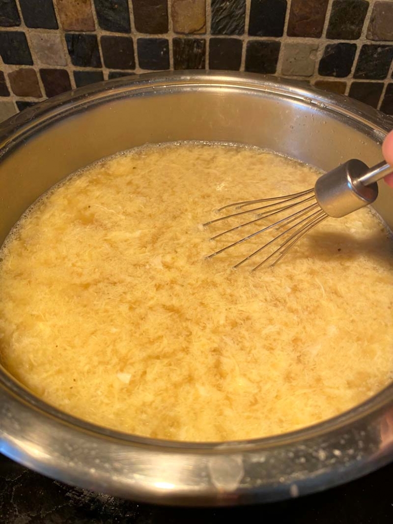 stirring egg drop soup in a pot