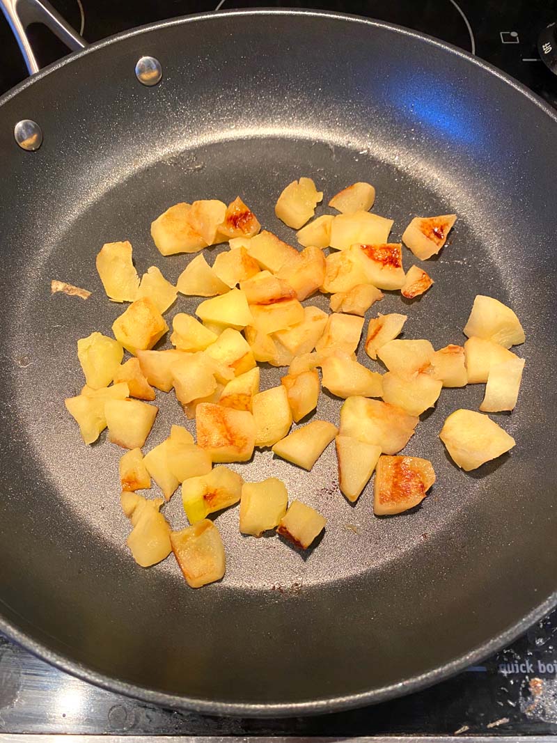 Chopped apples cooking in a skillet