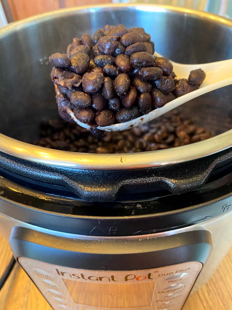 a scoop of cooked black beans 