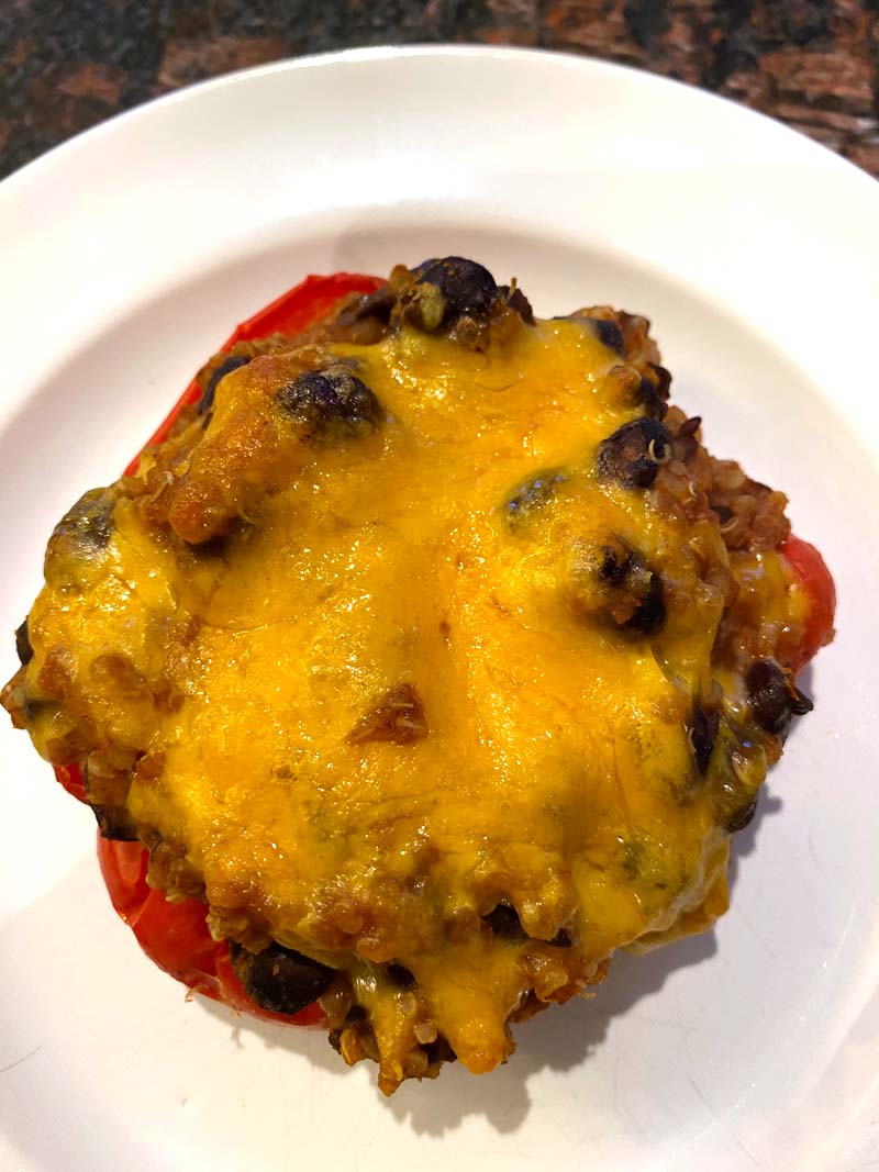 A vegetarain stuffed pepper on a white plate