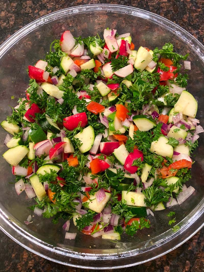 healthy salad with raw zucchini radishes bell peppers onions parsley