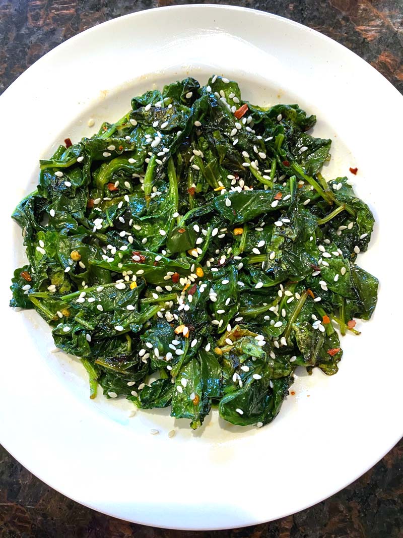 Sautéed sesame kale in a white bowl