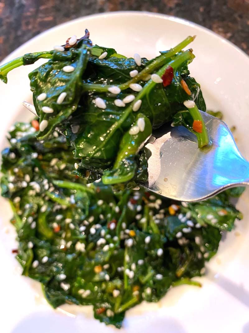 Close up of the cooked kale on a fork