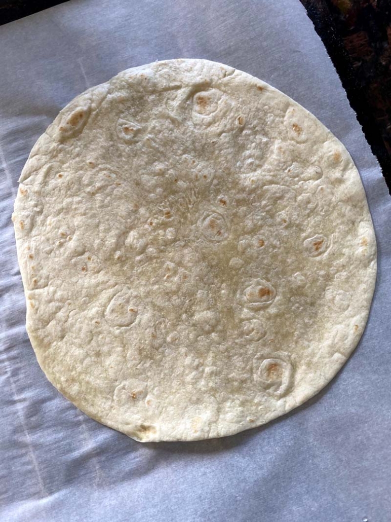 Flour tortilla on a baking sheet