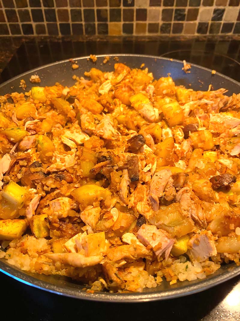 The cauliflower stir fry in a frying pan