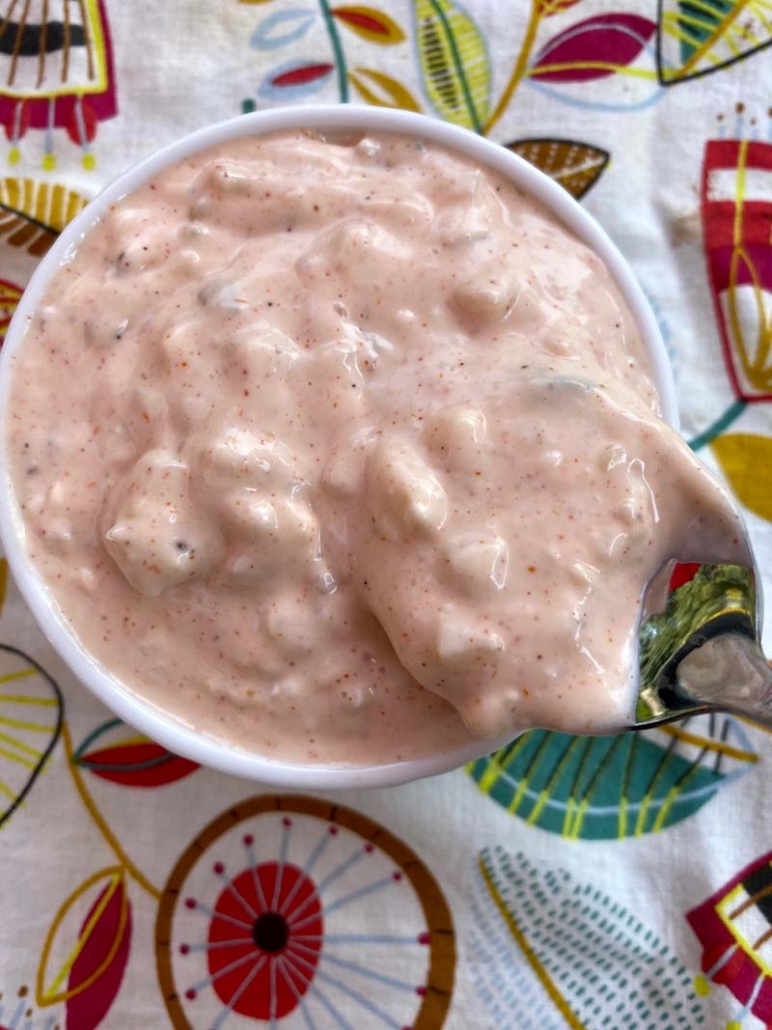 A spoon inside homemade thousand island dressing 