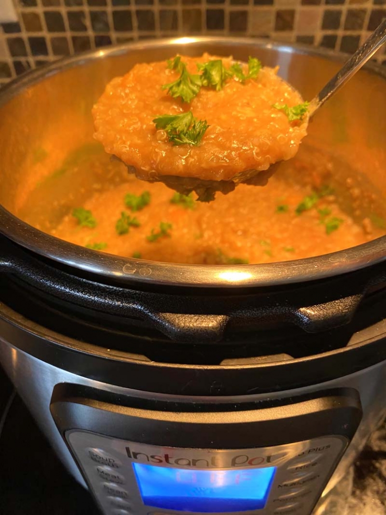 A ladle of Instant Pot Lentil Quinoa Soup