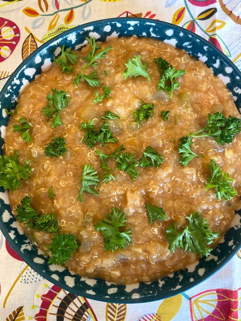 A bowl of Instant Pot Lentil Quinoa Soup with fresh chopped parsley