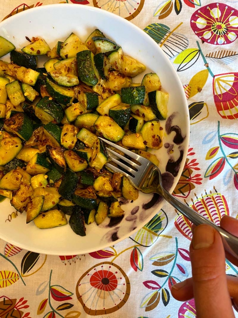 eating zucchini with a fork