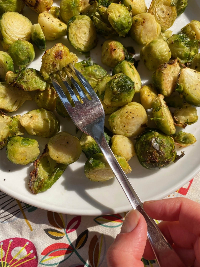 eating roasted brussel sprouts with a fork