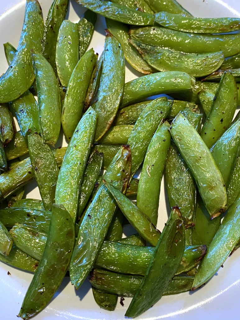 sugar snap peas on a white plate 