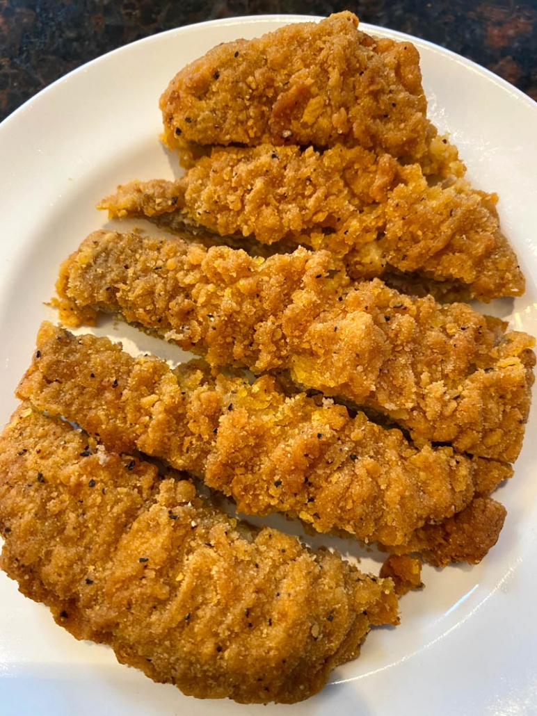 sliced country fried steak on a plate 