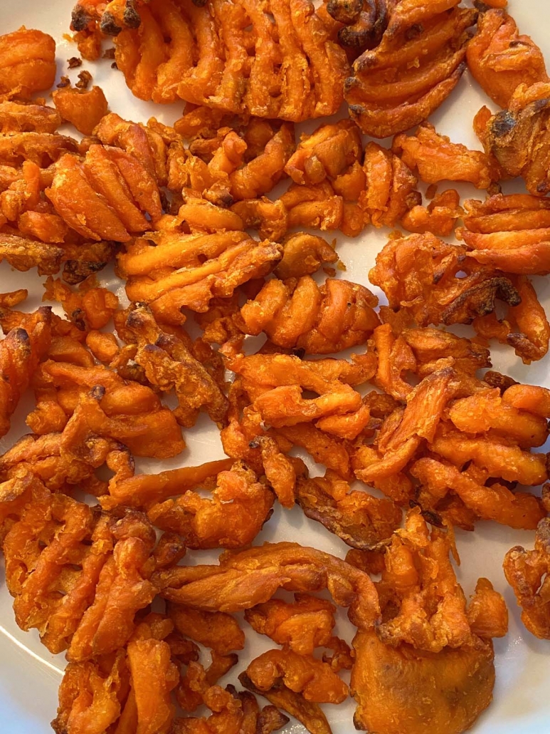 close up of sweet potato waffle fries on a plate