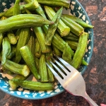 Air-fried okra on a plate, with a fork ready to eat.