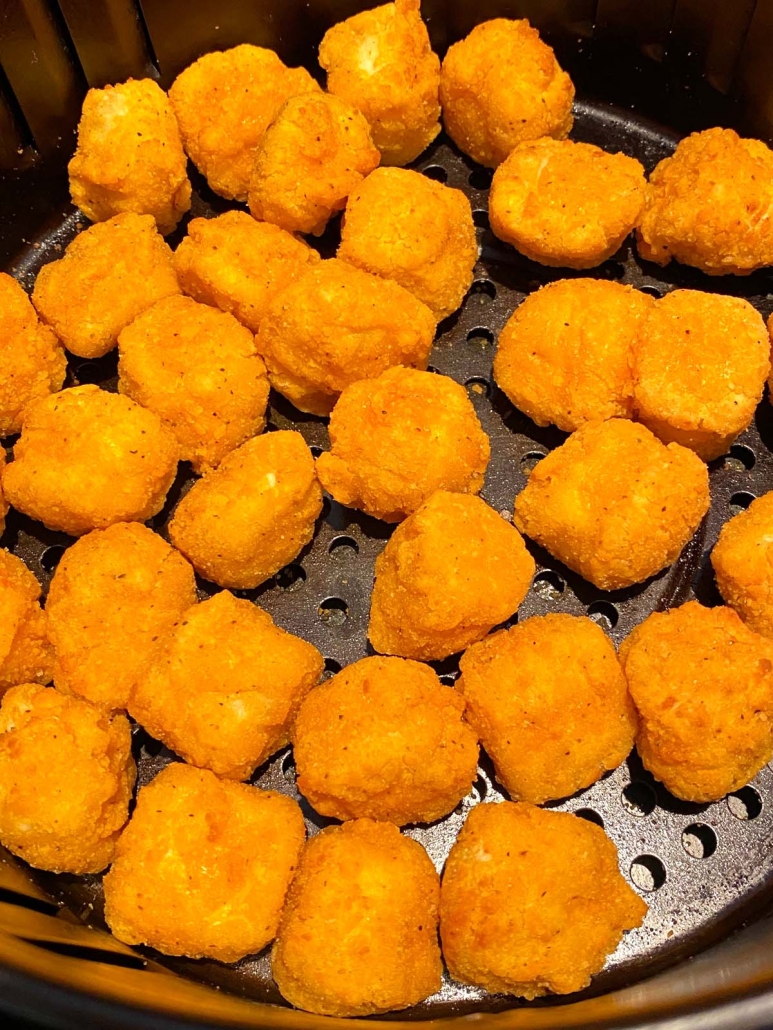 close up of popcorn chicken in the air fryer basket