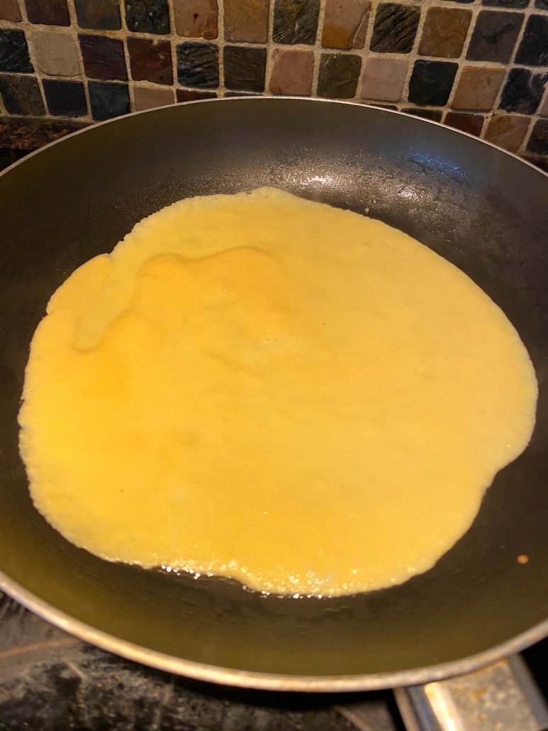 cooking coconut flour tortilla on a frying pan