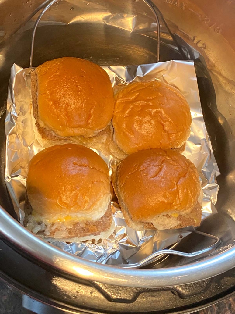 close up of four white castle sliders on top of foil in the instant pot