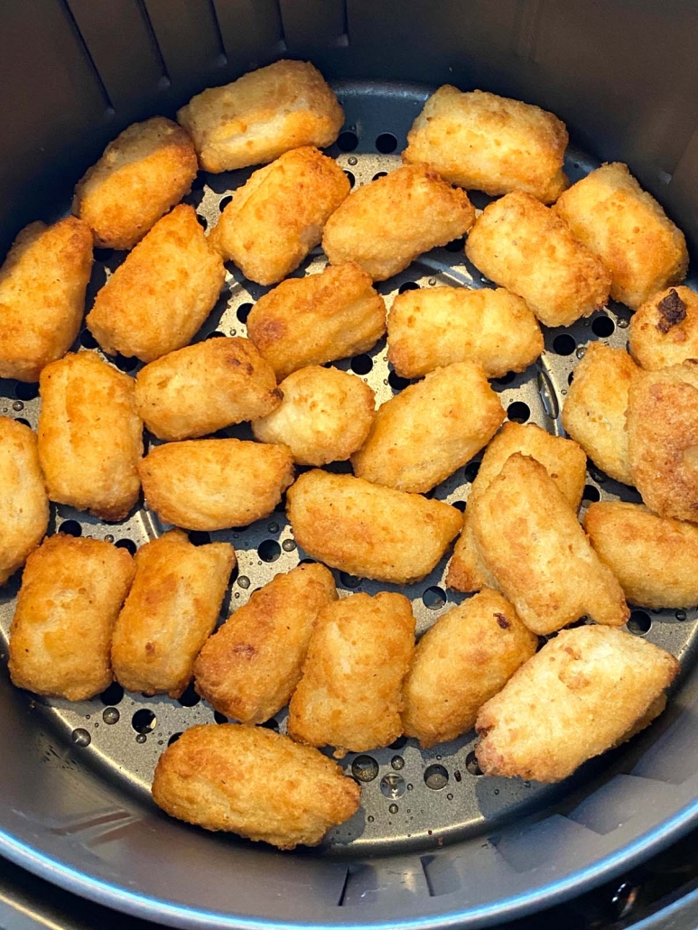 close up of air fried veggie tots in air fryer