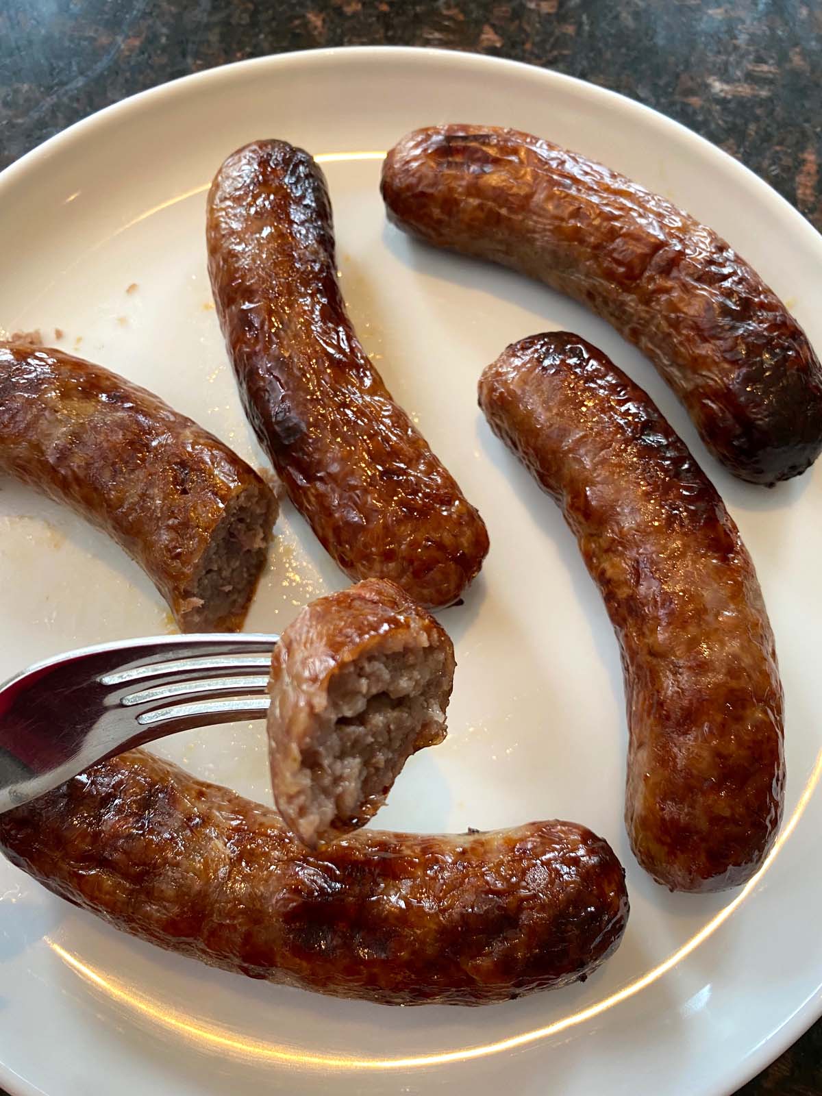 Cooked bratwurst on a plate.