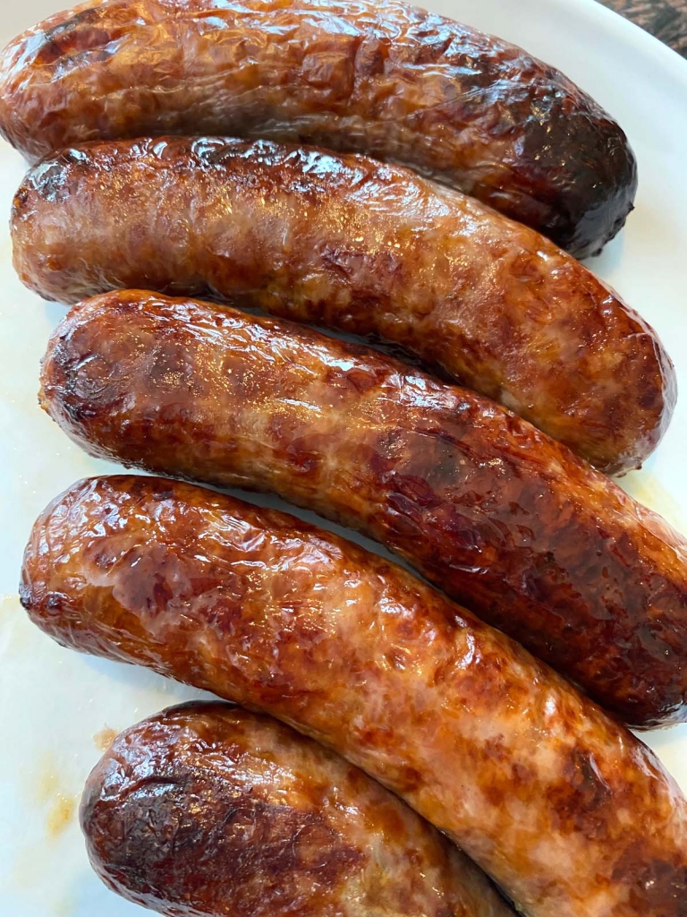 Cooked bratwurst on a plate.