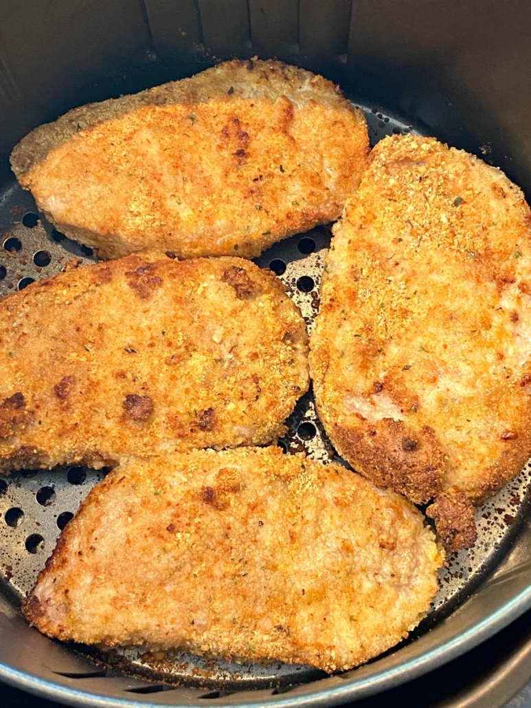 close-up of breaded pork chops in air fryer