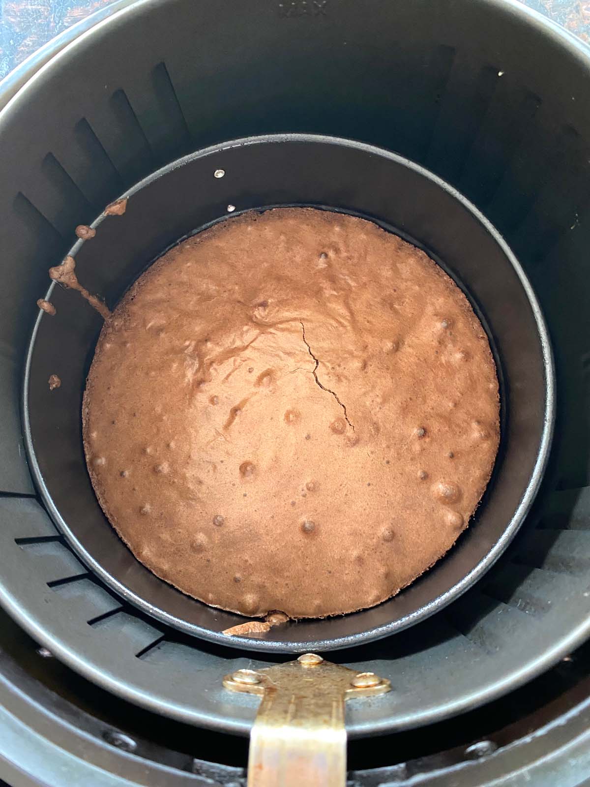 Overhead shot of brownie cooked in an air fryer inside the air fryer basket.