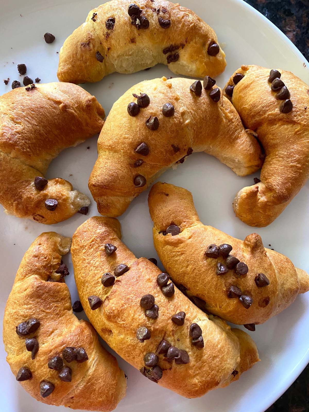 Chocolate croissants on a plate.
