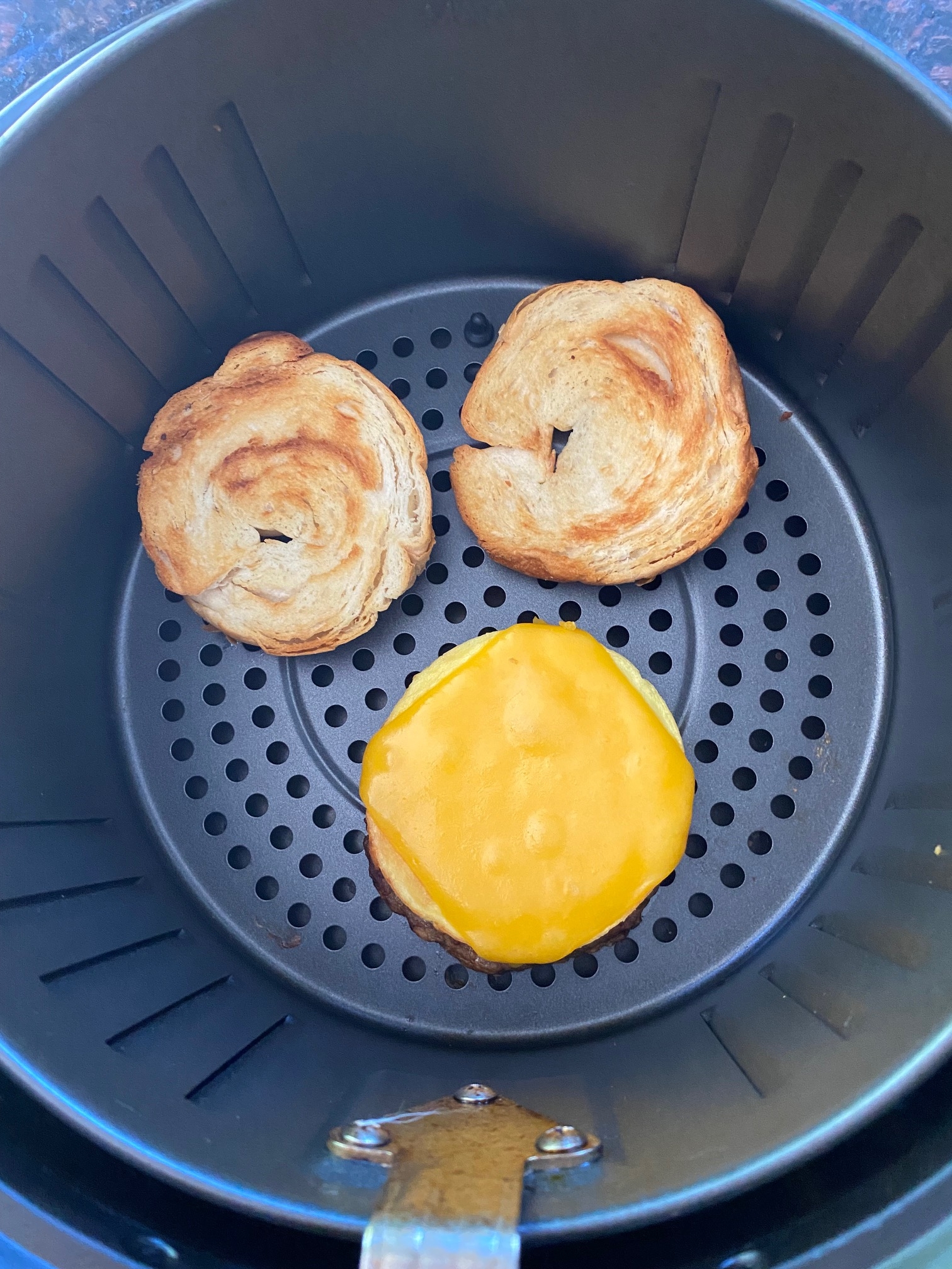 Breakfast croissant in an air fryer.