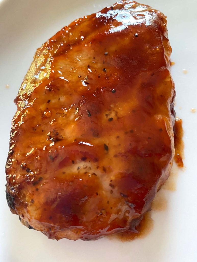 cooked boneless pork chop covered in bbq sauce