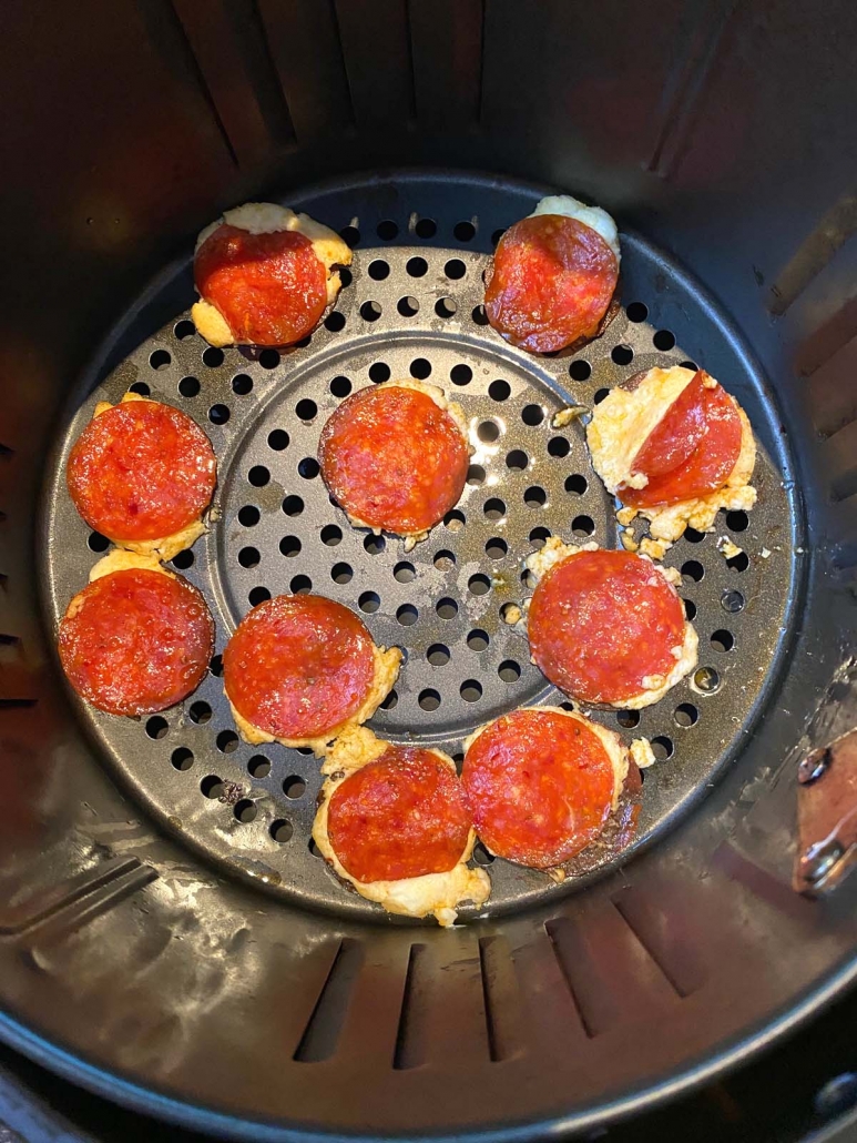 Pepperoni Cream Cheese Bites crisping up in air fryer