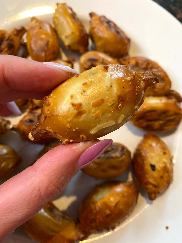 hand holding cooked pretzel bite