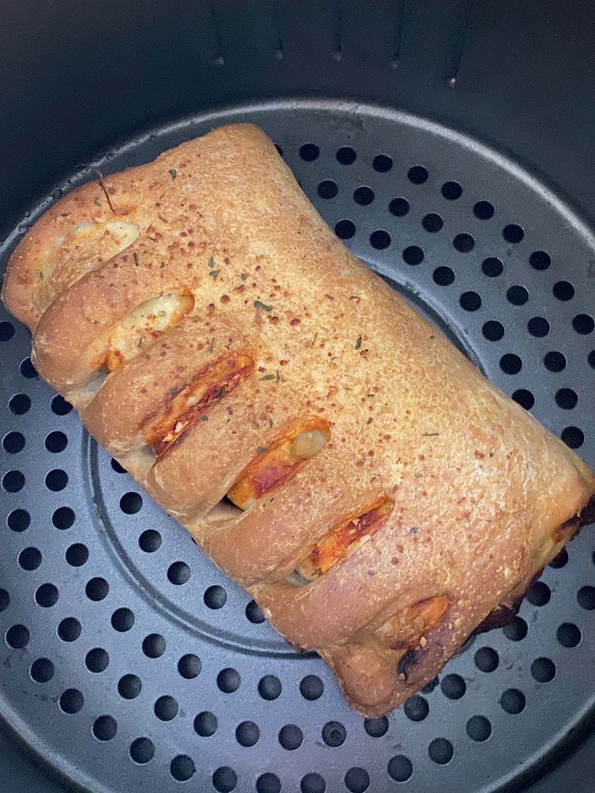 Cooked stromboli in an air fryer.