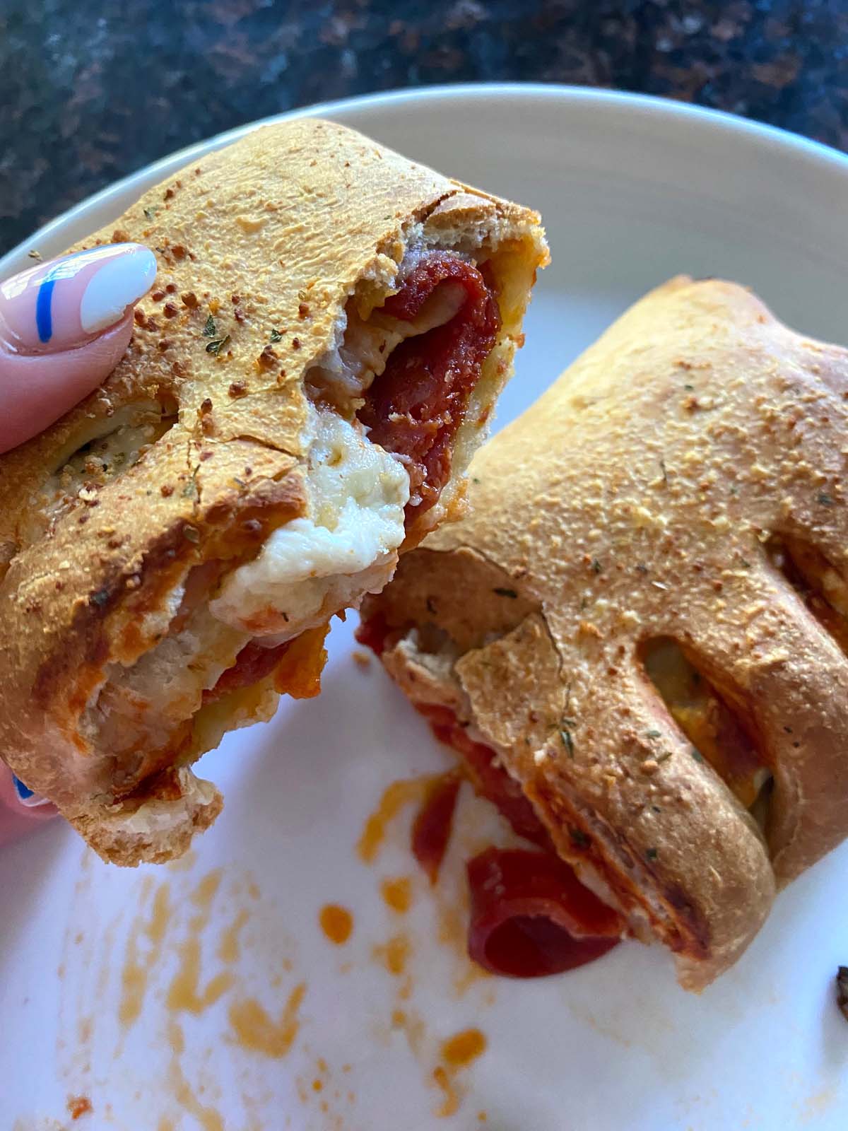 Cooked stromboli on a white plate.