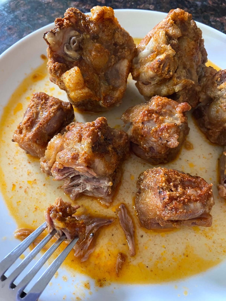 cutting into cooked oxtails with fork