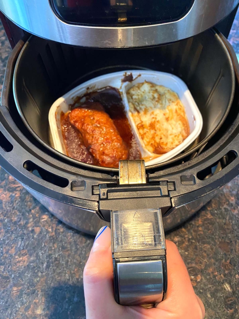 air fryer opened to show cooked meatloaf and mashed potatoes