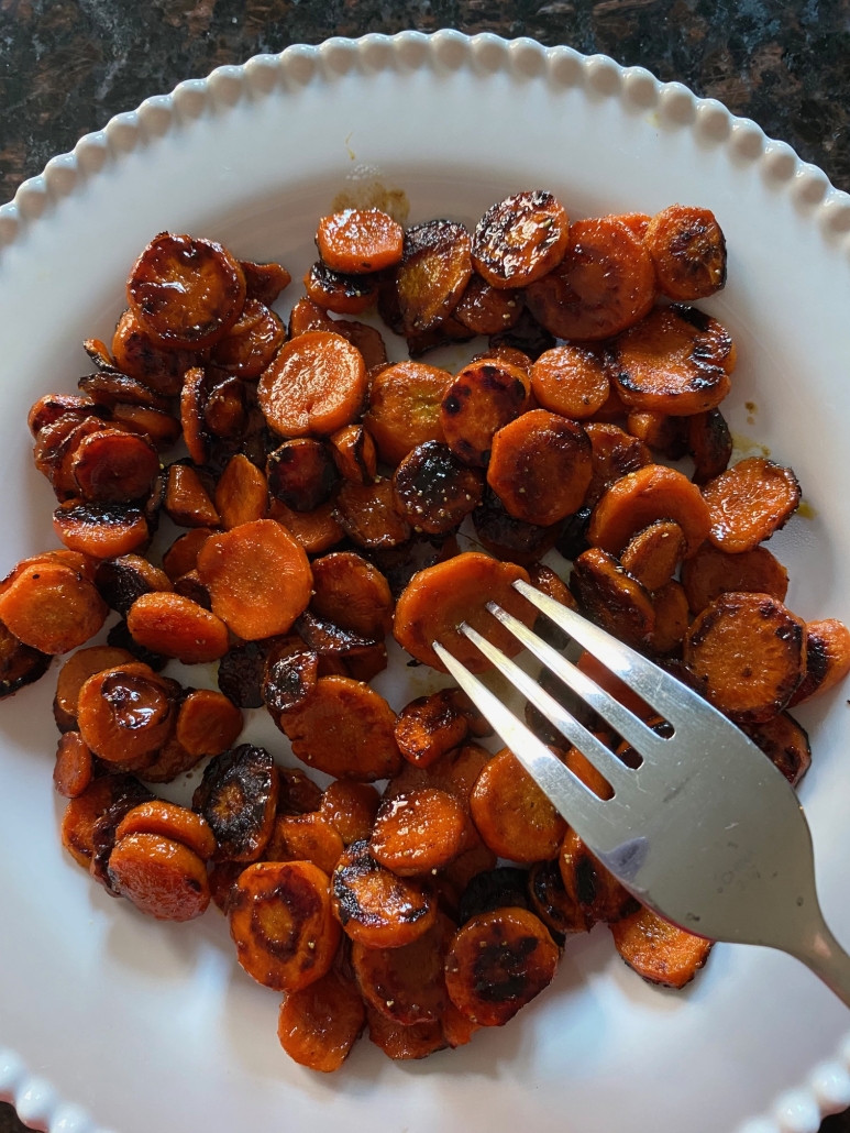 fork holding piece of sauteed carrot