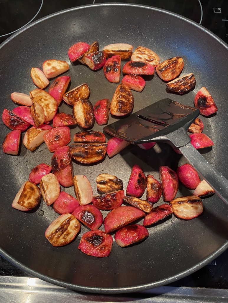 radishes cooking in a skillet