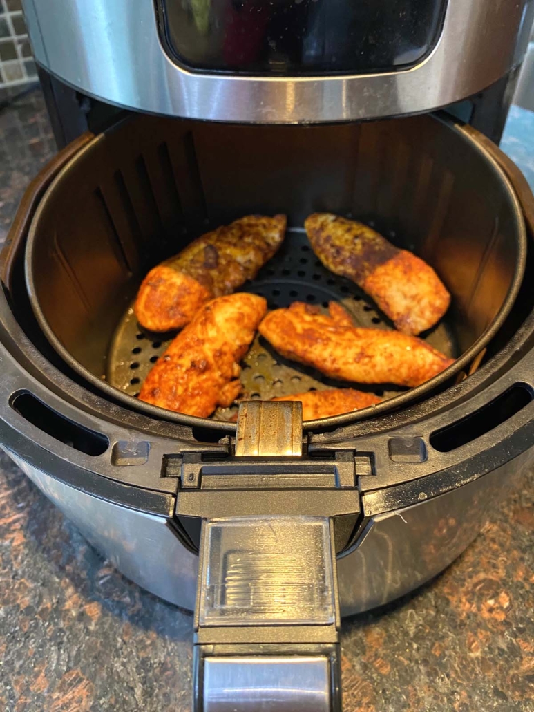 air fryer opened to show Chicken Tenders No Breading