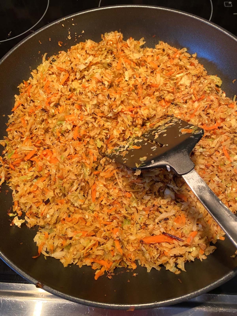 spatula mixing up Sauteed Cabbage And Carrots